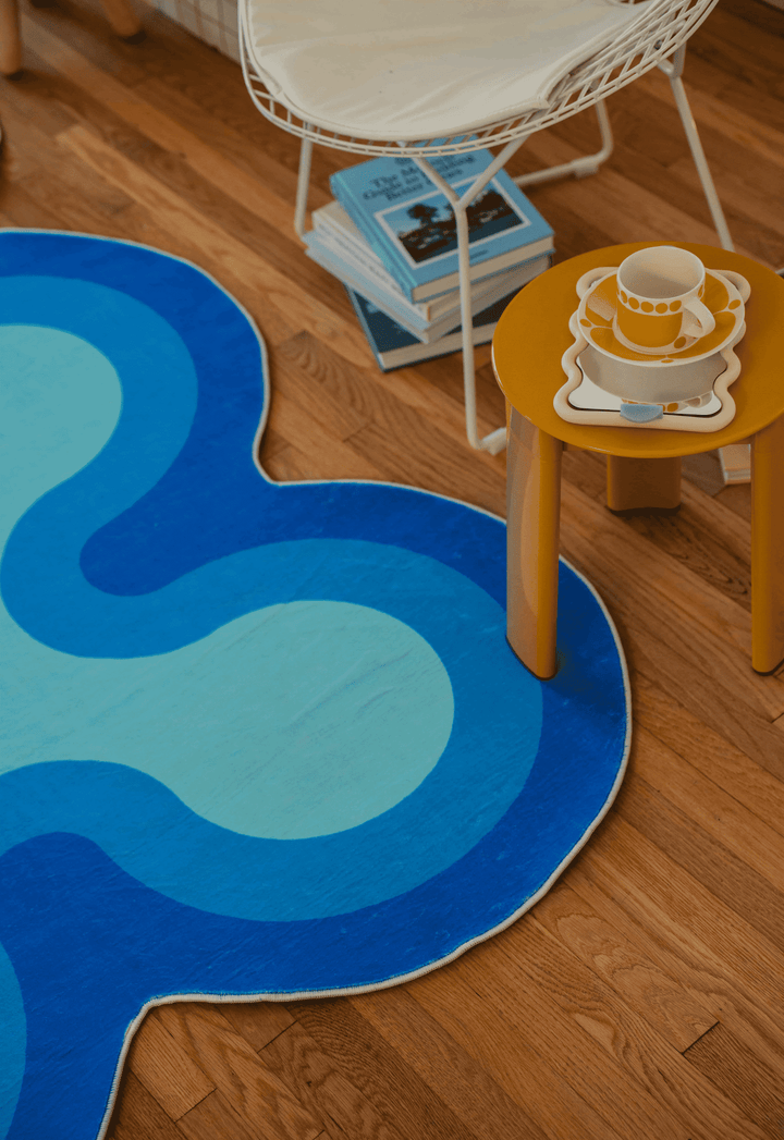 LanySpace Irregular Coral Blue Rug, 5x7, in the living room with a stand