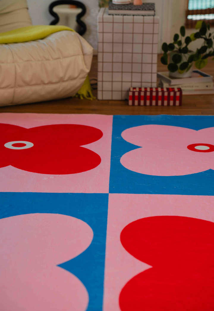 LanySpace Pink and Blue Four Leaf Clover Rug next to couch