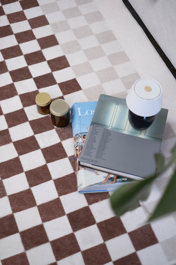 Books and jars on LanySpace Chocolate and Ivory Checkered Rug