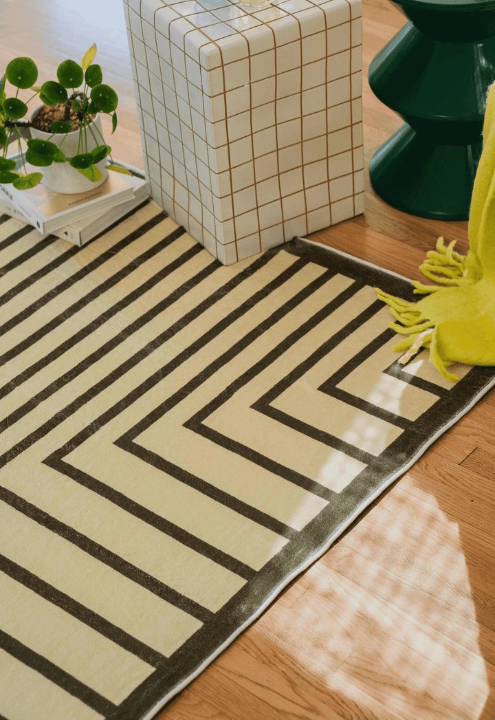 LanySpace Olive Green Striped Minimalist Rug in a corner