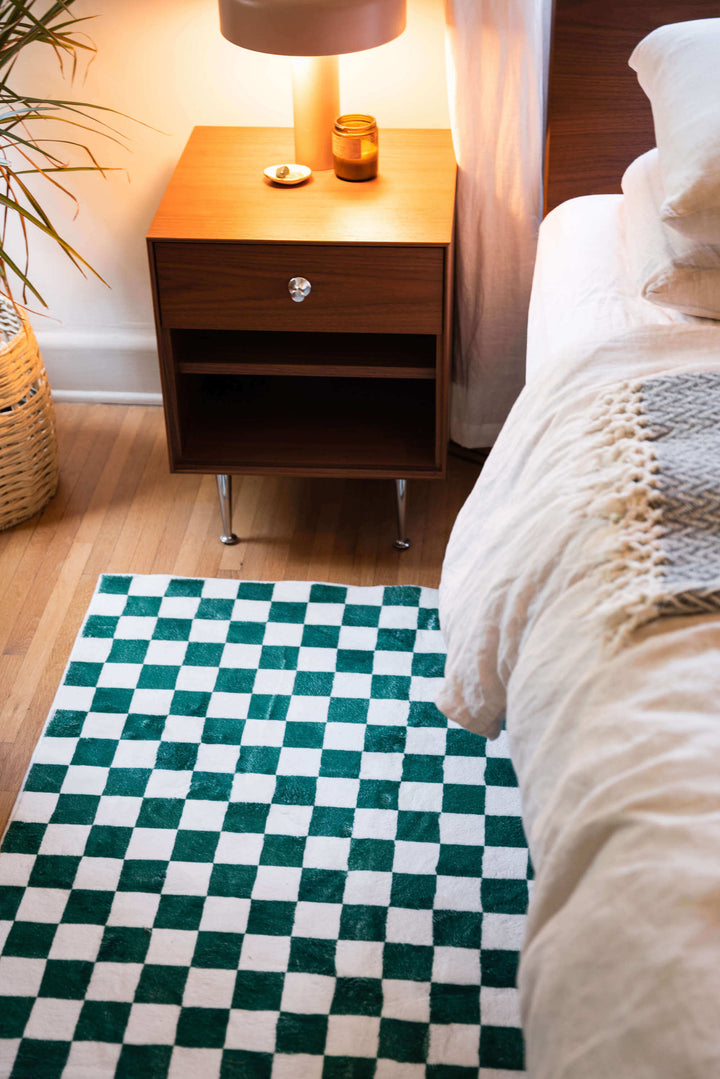 LanySpace Emerald Green Checkered Rug at the head of the bed