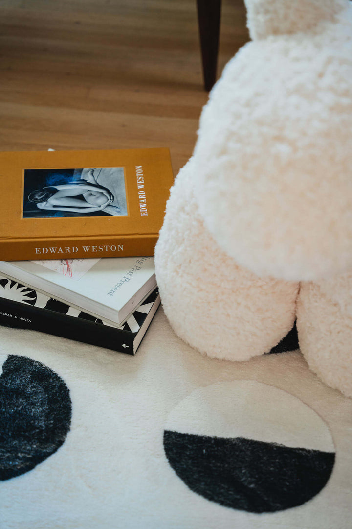 Books and a pony chair on the LanySpace Lunar Eclipse Rug