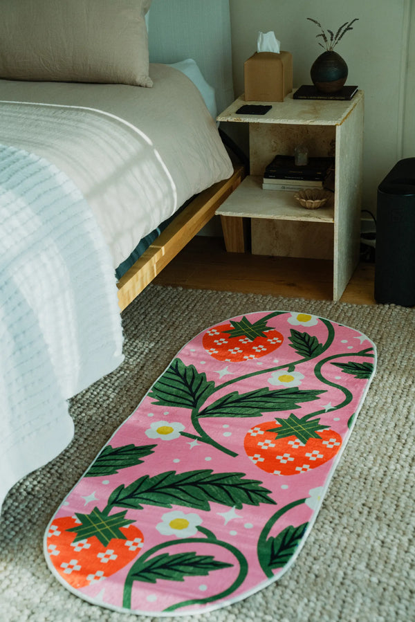 Lany Space x Megan Roy Sicilian Strawberry Pink Runner Rug placed by the bed