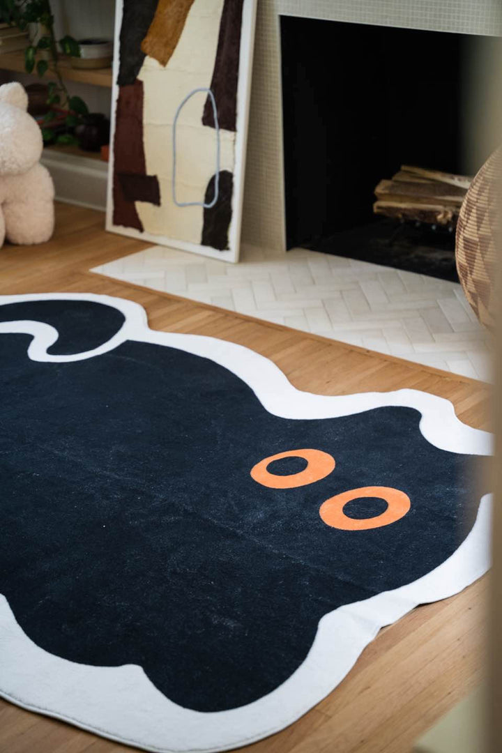 LanySpace Cute Black Cat Rug next to the Fireplace